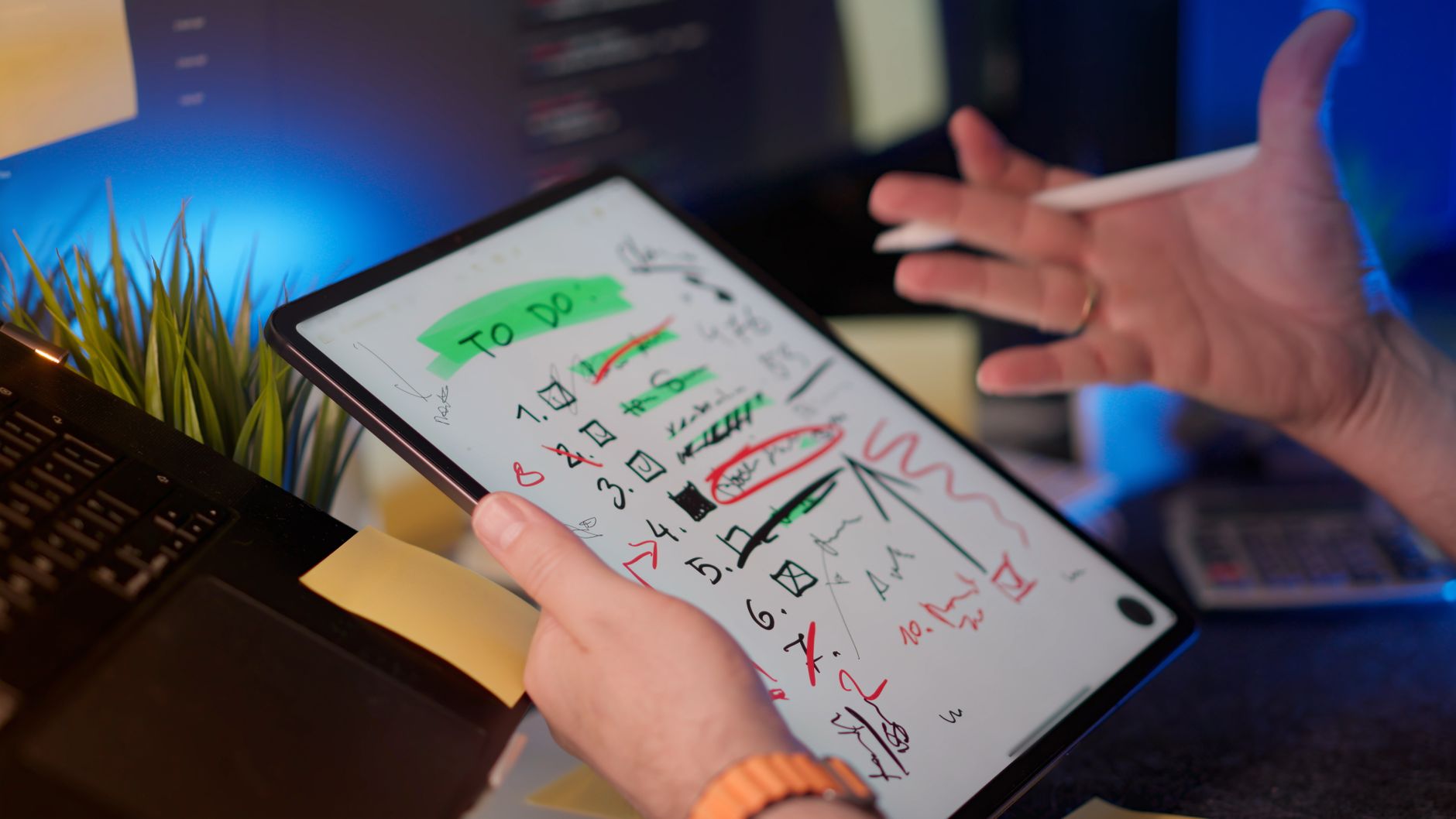 Hands typing on a laptop with a long document open on screen