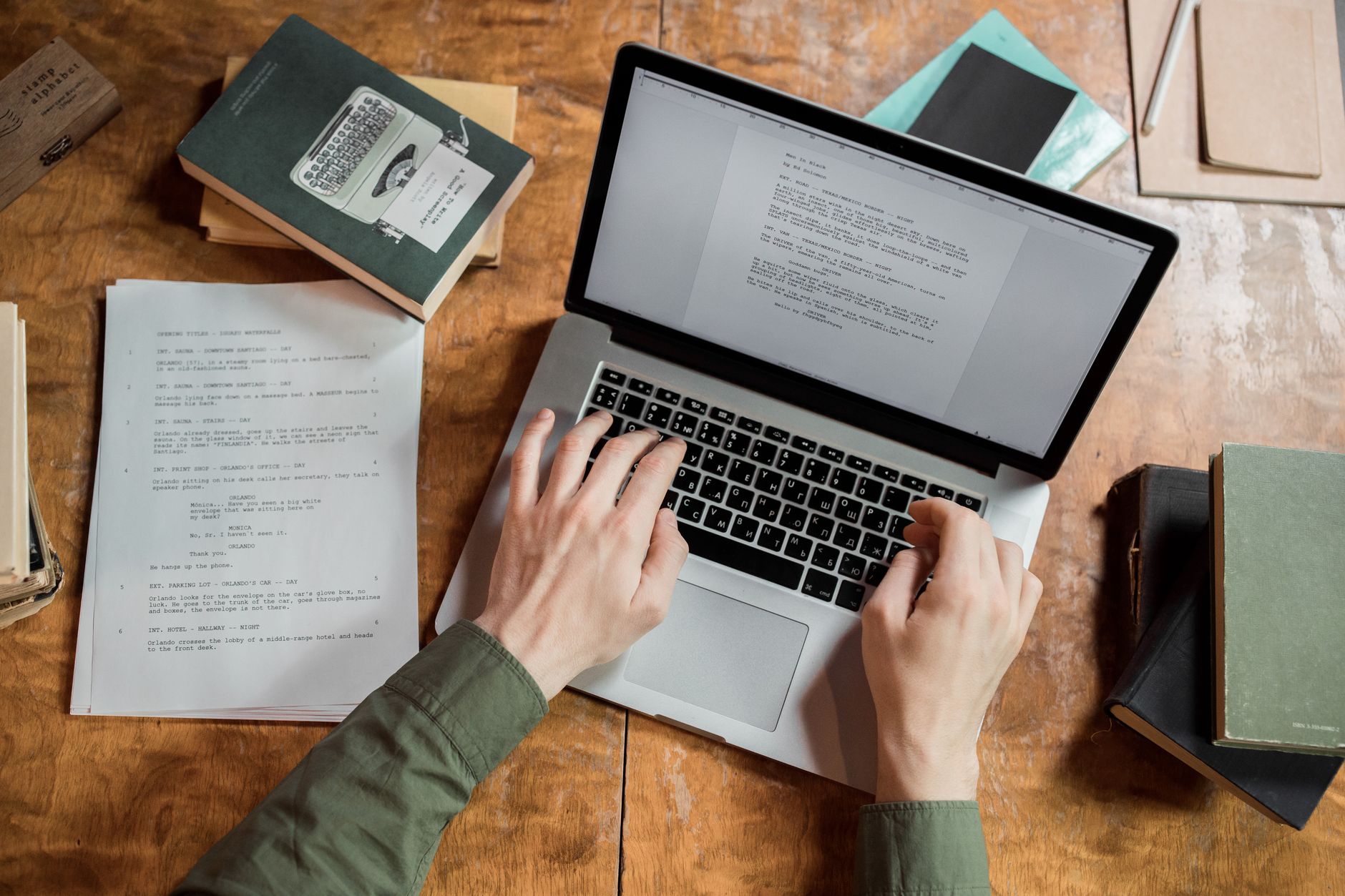 Two marketers look at AI generated copy on a laptop screen in an office.