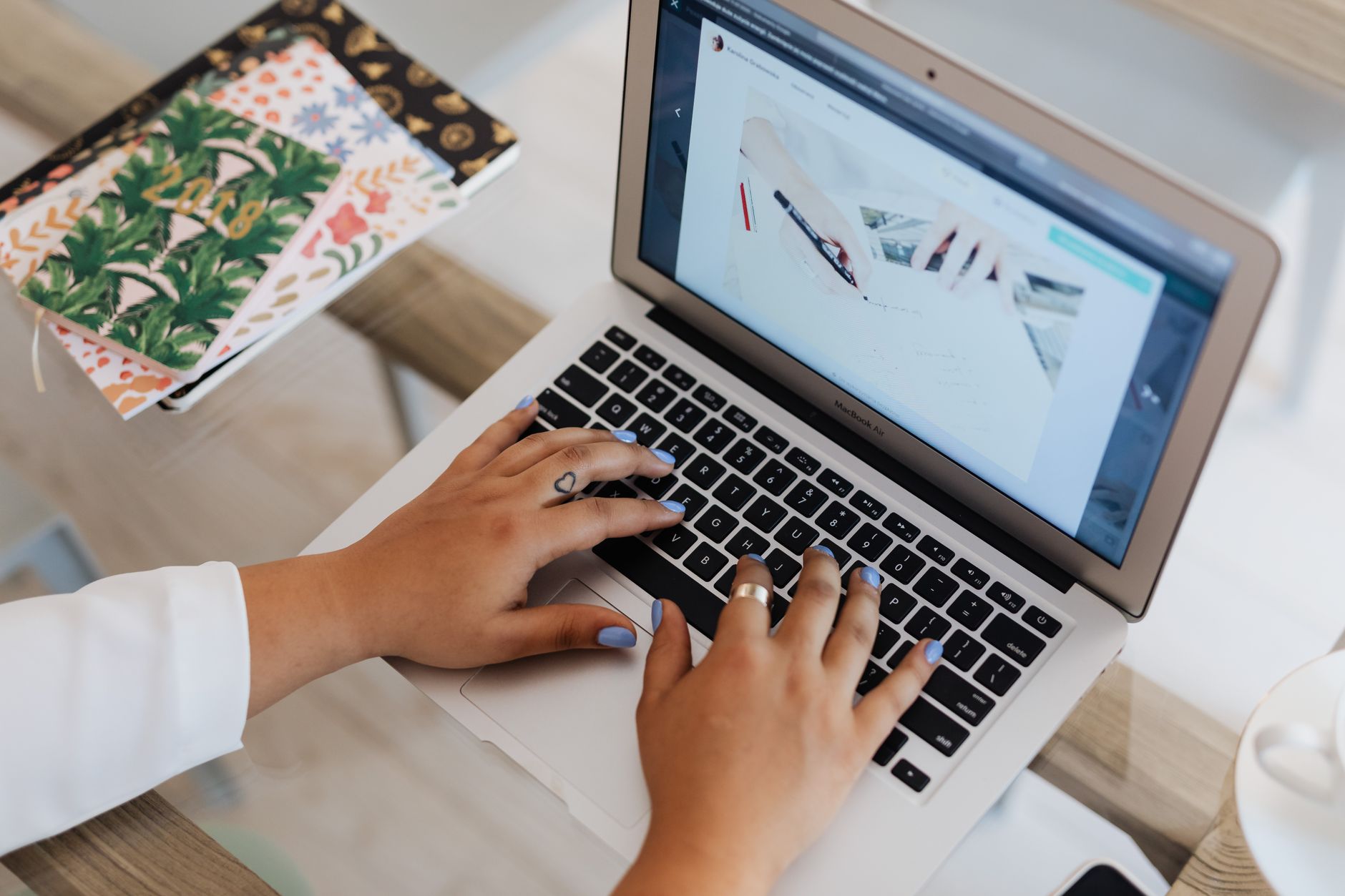 Marketing team members reviewing a content calendar on a laptop