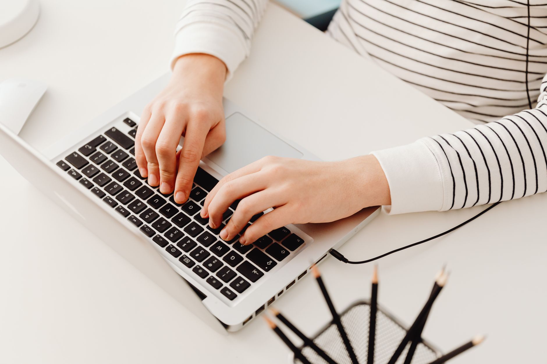 Person looking at a laptop showing subscription billing dashboard with failed payments
